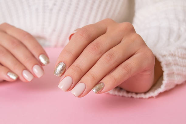 istock Female hands with beige manicure nails 1359589801