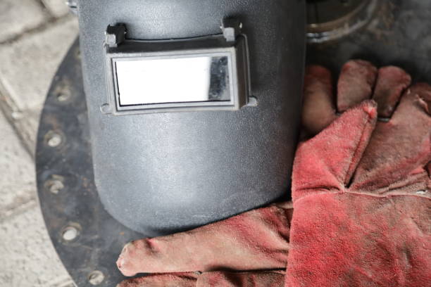 istock welding helmet and welding gloves, construction worker protective equipment concept 1359589881