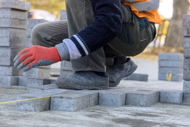 istock Installation of concrete bricks during sidewalk construction 1359589912