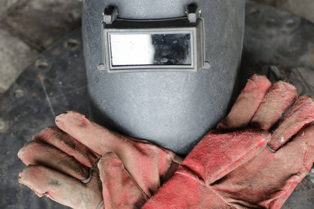 istock welding helmet and welding gloves, construction worker protective equipment concept 1359590470