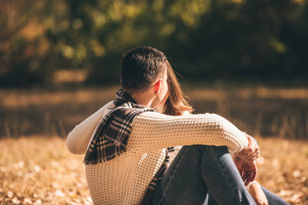 istock Happy couple resting in the park 1359590820