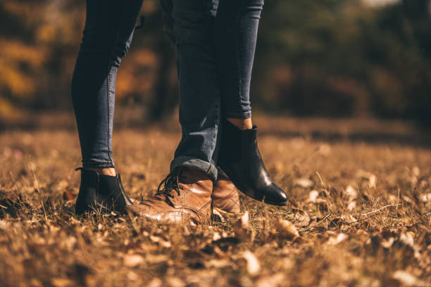 istock Young couple standing on the green grass 1359591351