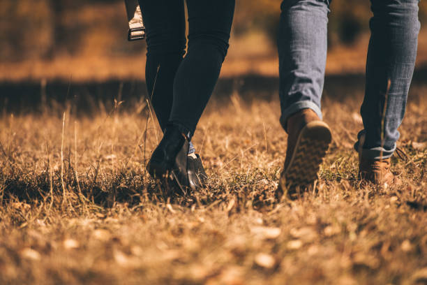 istock Modern couple walking on autumn leaves 1359591362