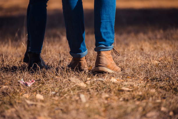 istock Couple in boots standing on the grass 1359591363