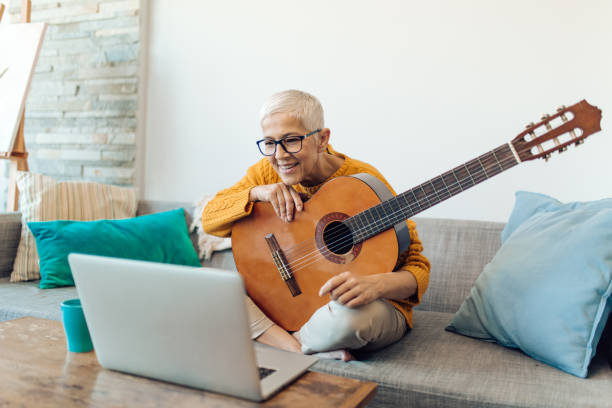istock Senior woman having an online guitar class 1359591882