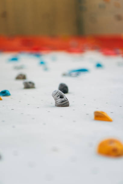 istock White climbing wall with colorful rocks 1359595918