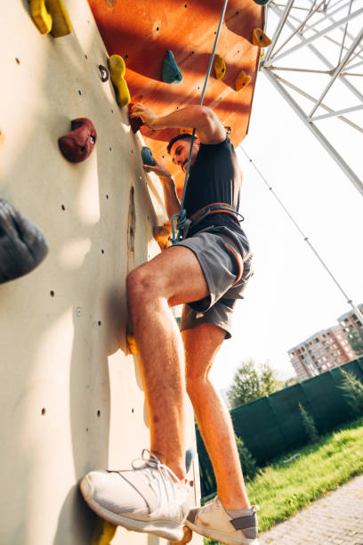 istock Man climbing wall with grips 1359595922