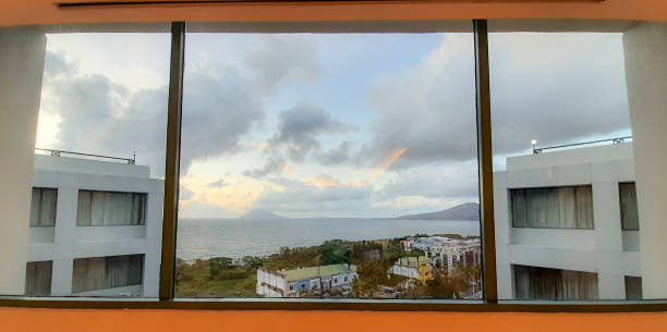 istock looking at the sea and mountains from the window 1359597646
