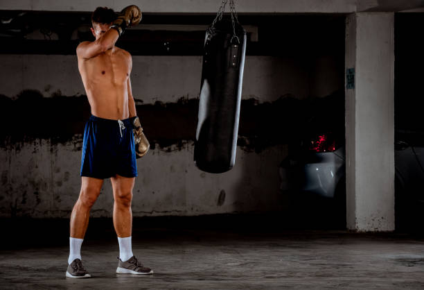 istock Young man prepares for workout in car garage 1359599844