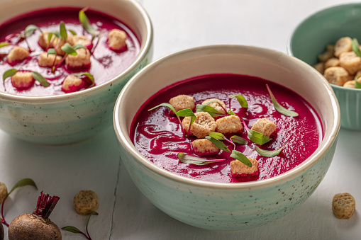 Veggie borsch soup with croutons and cream. Cream of beetroot with cream.