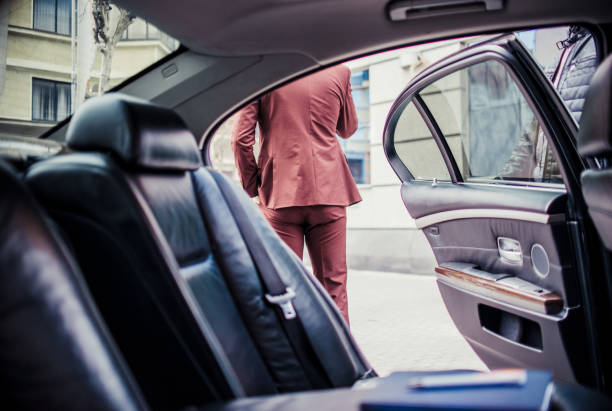 istock Man in suit speaking on mobile near the luxury car 1359604803