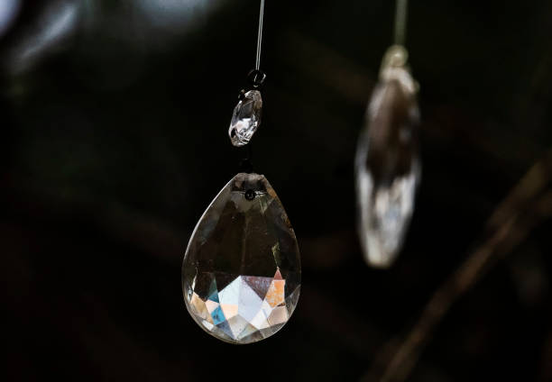 Crystal glass hanhging from the gables in a garden