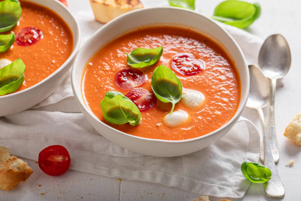 istock Red creamy tomato soup made of cherry tomatoes and basil. 1359604940