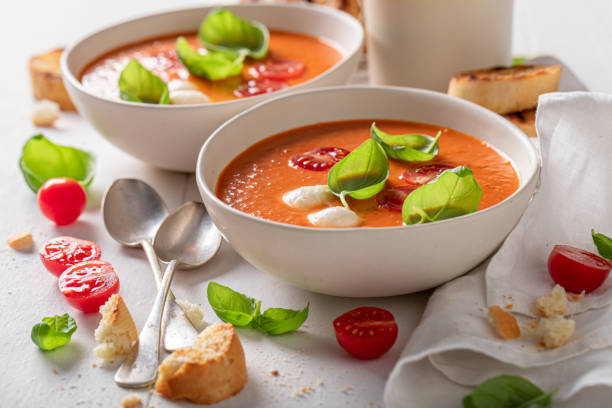 istock Tasty creamy tomato soup with mozzarella cheese and crostini. 1359604947