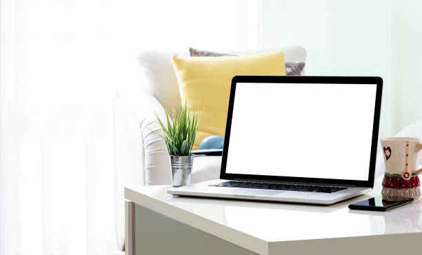 istock Mockup blank white screen laptop computer in living room. 1359613679
