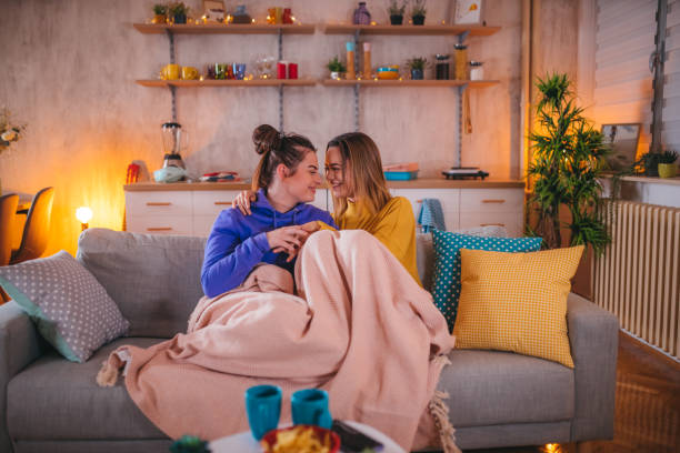 istock Lesbian couple share cuddling on the couch 1359613695