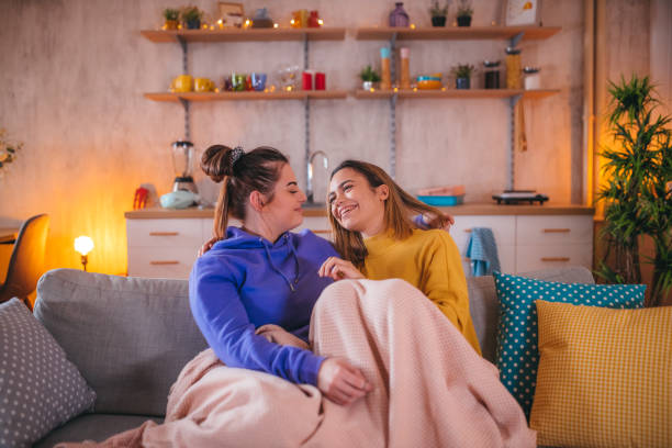 istock Lesbian couple share cuddling on the couch 1359613717