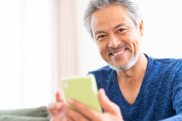 istock elderly man who uses smart phone, 1359613828