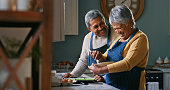 istock Shot of a happy senior couple baking at home 1359618517