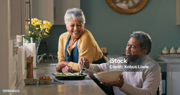 Shot Of A Happy Senior Couple Baking At Home Stock Photo - Download Image Now - Wheelchair, Adaptation - Concept, Cooking