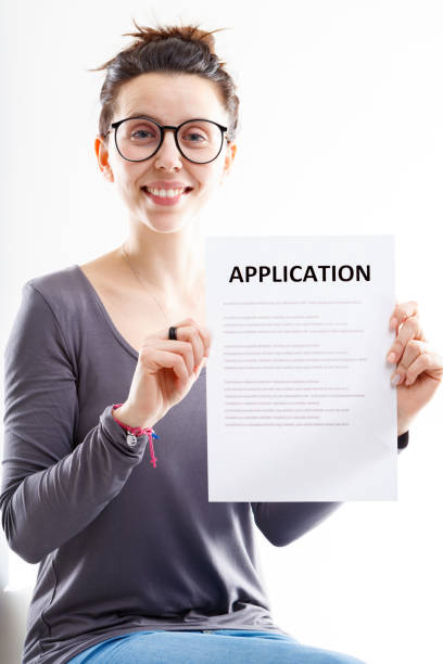 istock smiling woman holding an application form 1359619222