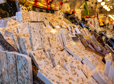 Bergamo, Italy. View of the Christmas market in the city center. Stalls selling different types of nougat