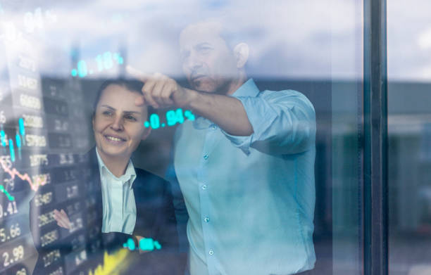 istock Busines couple watching stock market data on a modern interface 1359623740