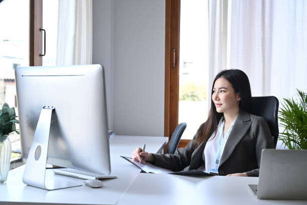 istock Successful businesswoman working with computer in office. 1359625790
