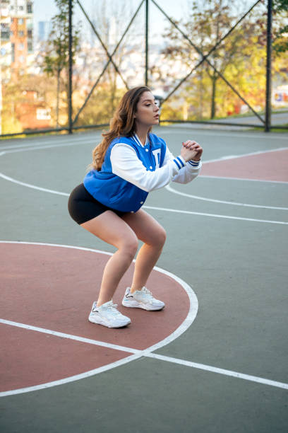 istock Fitness woman doing squats 1359628571