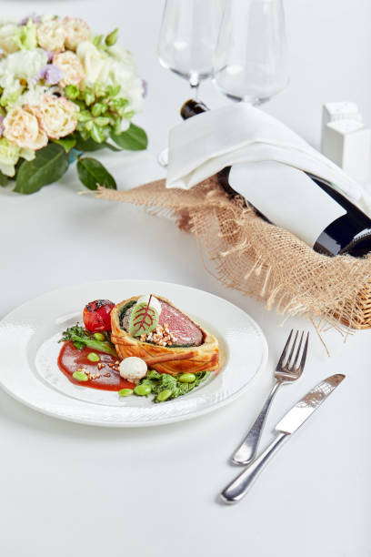 istock Meat roll sliced on a dish with vegetables on a festive table 1359638188