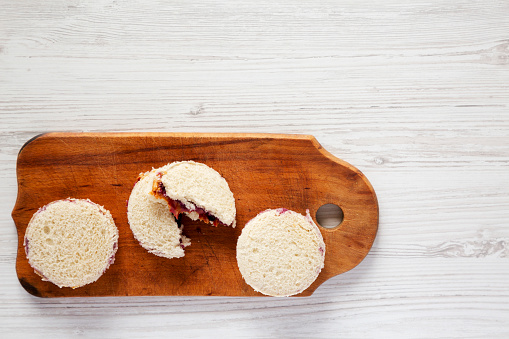 Homemade Crustless Peanut Butter  and Jelly Circles on a rustic wooden board, top view. Flat lay, overhead, from above. Space for text.