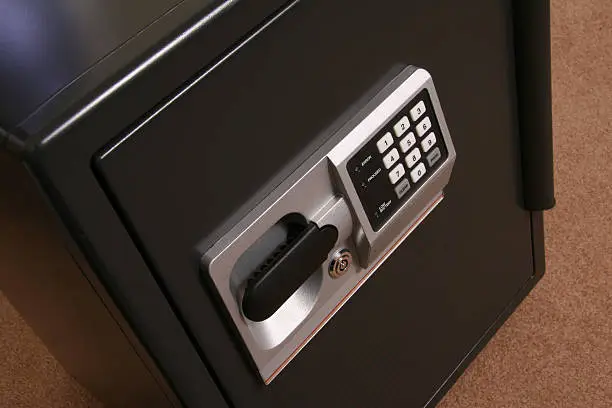 Small Business Safe. Large household safe. Fire Safe. Lock box. Combination and key locks. Focus is on the keypad and handle.