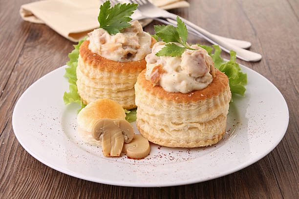 2 vol-au-vents filled with mushroom and chicken plate of gourmet vol au vent chicken meat photos stock pictures, royalty-free photos & images