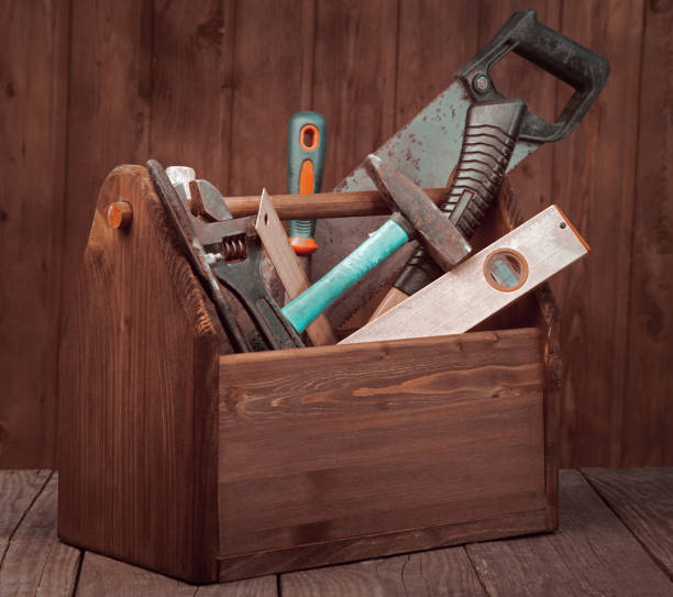istock grungy old tools on a wooden background front view. 1359645131