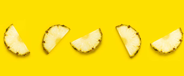 istock Pineapple slice against on a yellow background. Top view, flat lay. Banner 1359646895