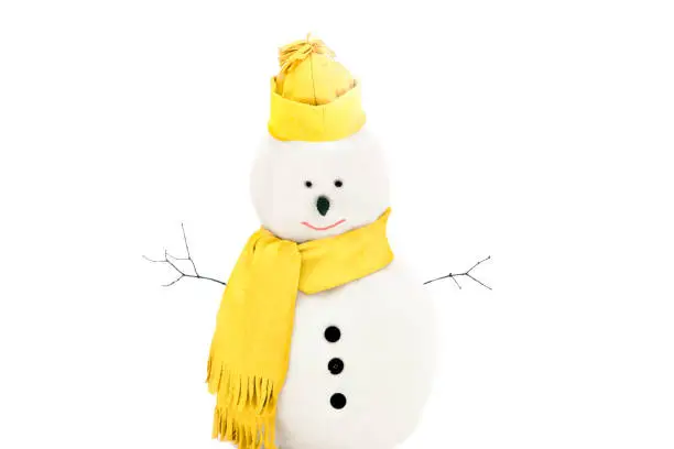 Photo of Snowmen wearing winter hat. scarf on a white background in trendy yellow color of 2021.