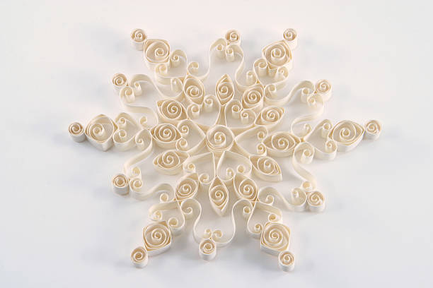 Paper Quilled 12 Point Snowflake on White Paper Quilling or Paper Filigree Snowflake patterns. 12 point flake. paper quilling stock pictures, royalty-free photos & images