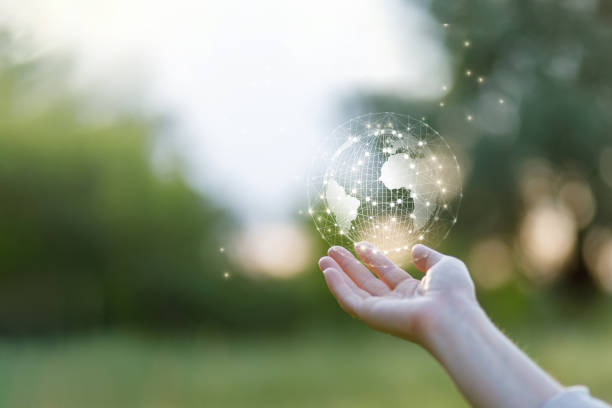 istock Hand shows the Globe and the network on a blurred green background. 1359653461