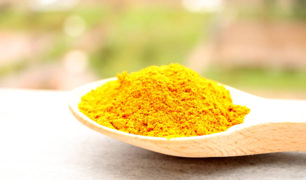 istock curry powder spice in a wooden spoon 1359653496