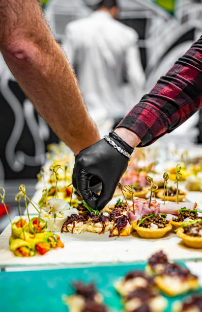 istock Chef hand is in process of Preparing catering food 1359654584