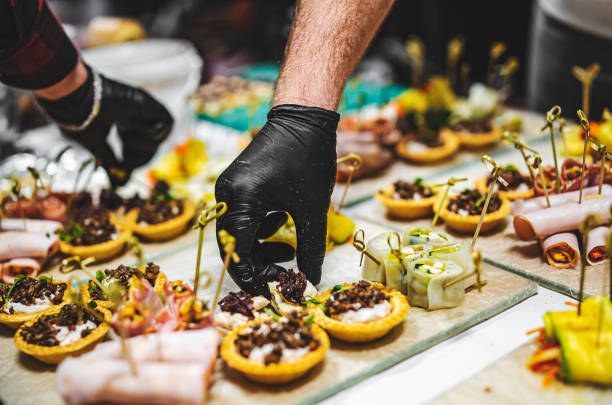istock Chef hand is in process of Preparing catering food 1359654590