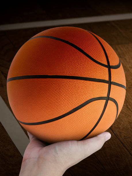 istock Basketball player holding a ball 1359658163