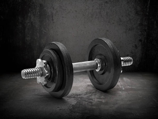 istock Dark gym interior with black dumbbells 1359658277