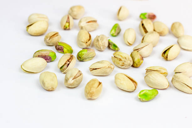 istock Roasted salted pistachio nuts in nutshell on light background 1359661613
