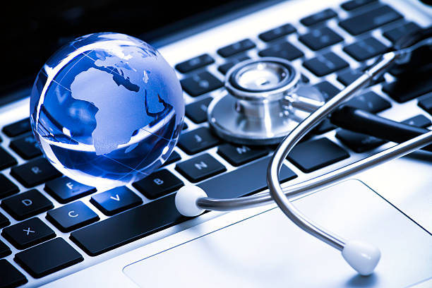 istock Stethoscope rests on a keyboard and blue globe adjacent 135966316