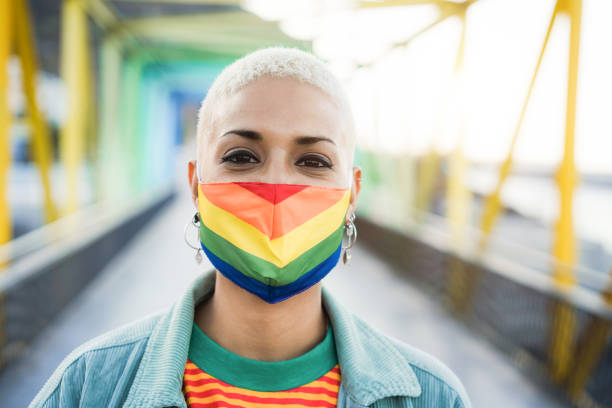 istock Young lesbian wearing LGBT rainbow flag pride mask - Focus on face 1359664965
