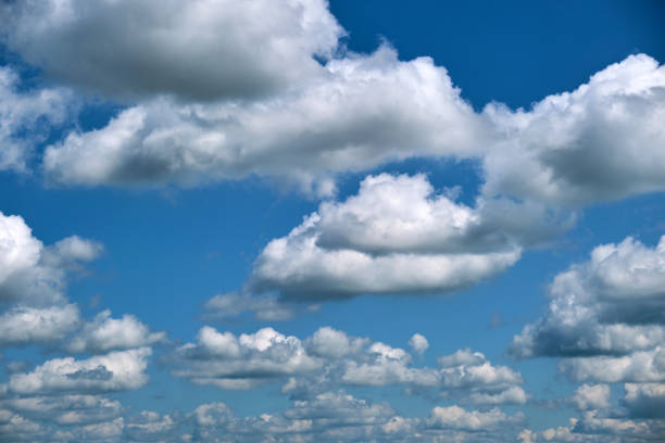 istock Bright landscape of white puffy cumulus clouds on blue clear sky. 1359666093