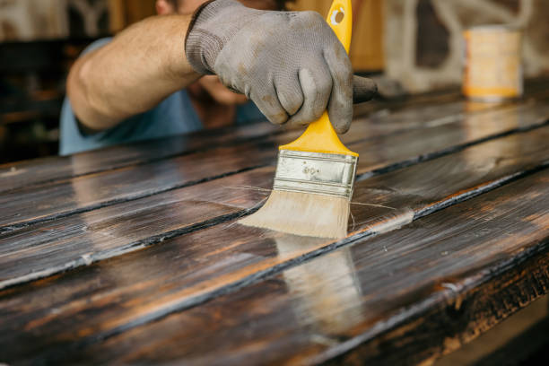 istock Adult man painting table,checking if everything is painted 1359667165