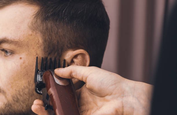 istock Hair cutting process with hair clipper. 1359669616