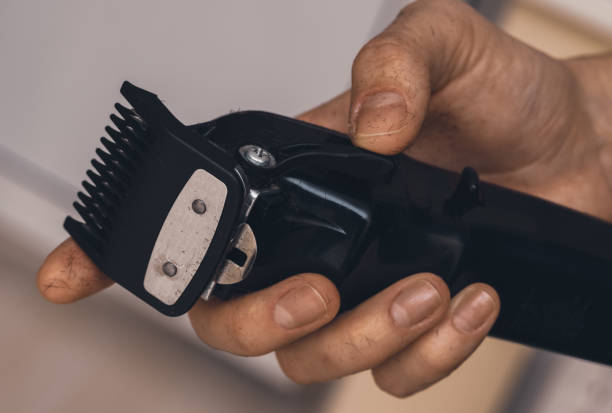 istock Hair clipper in barber's hand. 1359669631